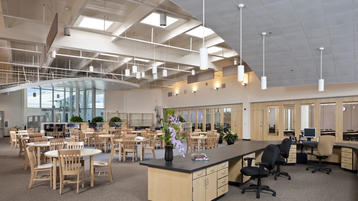 Dublin High School-from circulation desk,looking towards western entry, tables, stacks and lecture rooms with natural light bathing the interior space.